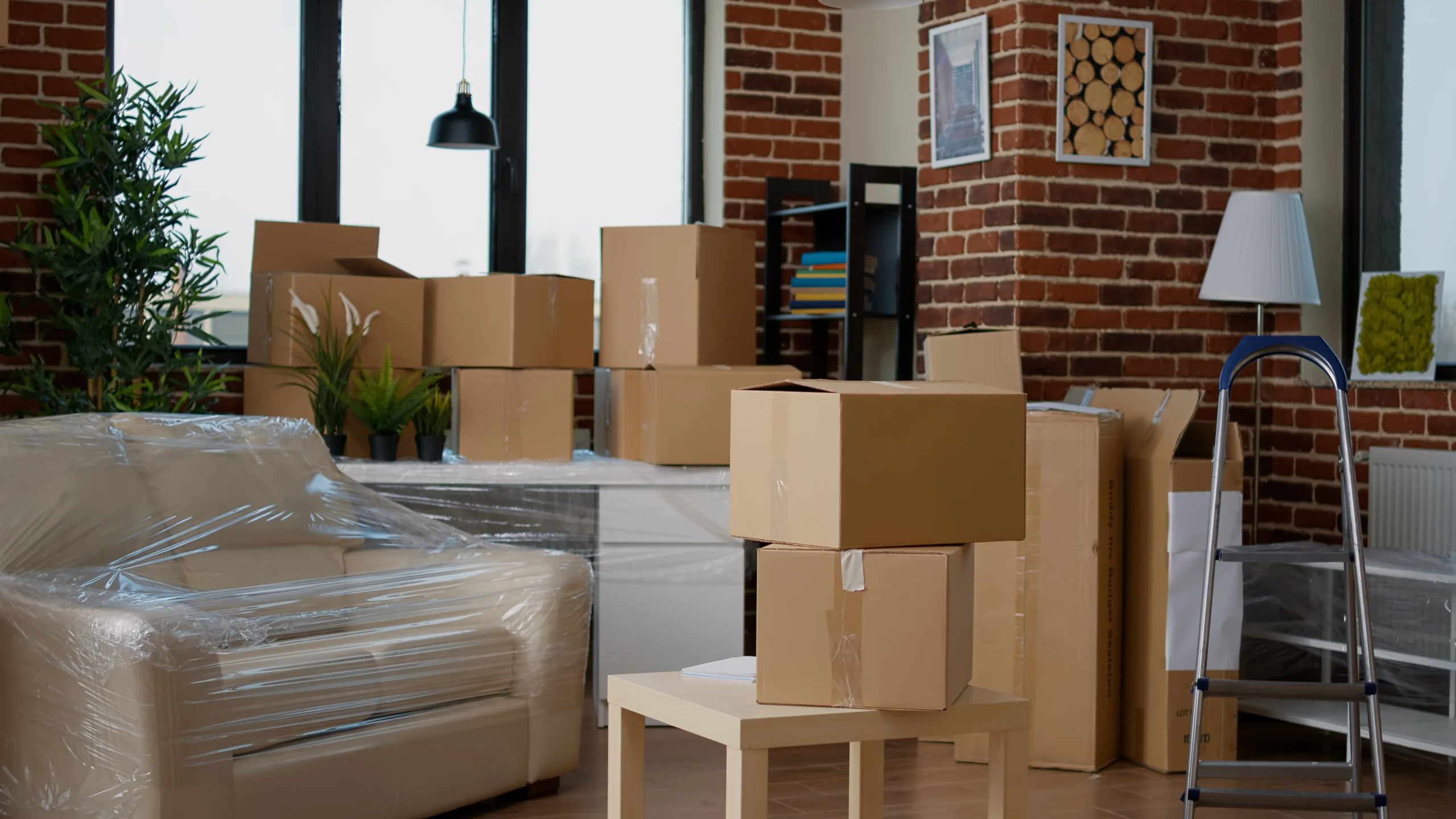 nobody-empty-living-room-with-cardboard-packaging-new-home-furniture-things-stack-carton-boxes-no-pe